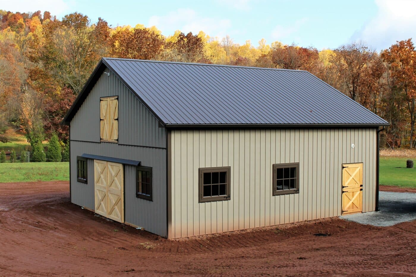 Ash gray board and batten barn with burnished slate roof